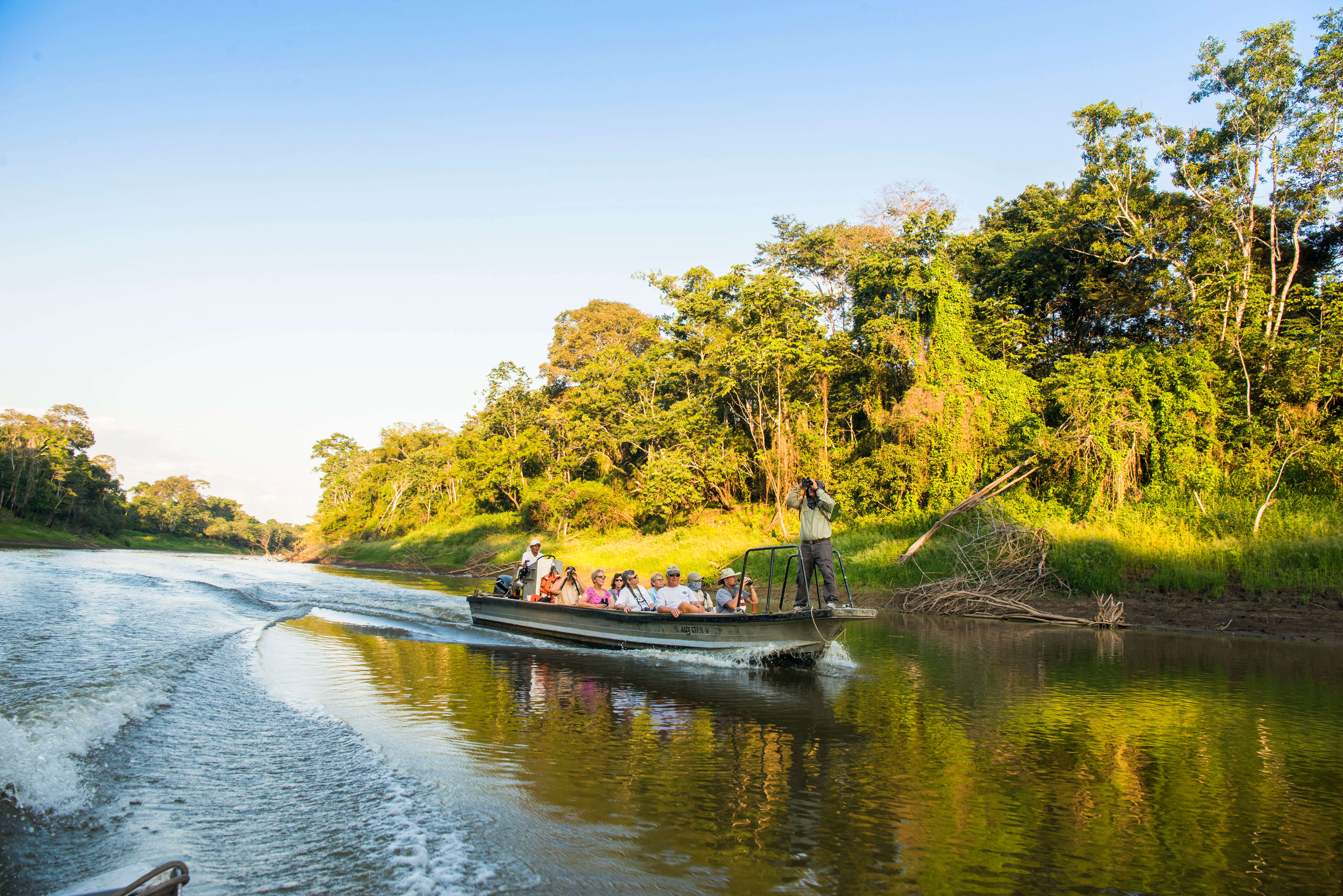 Passengers of the Delfin II on a skiff xploring the waters of the Amazon